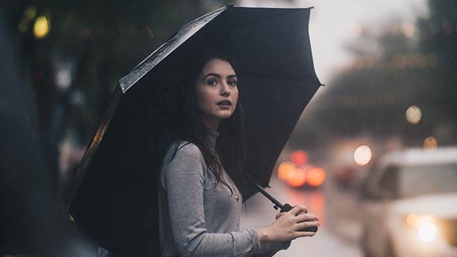 woman standing under an umbrella