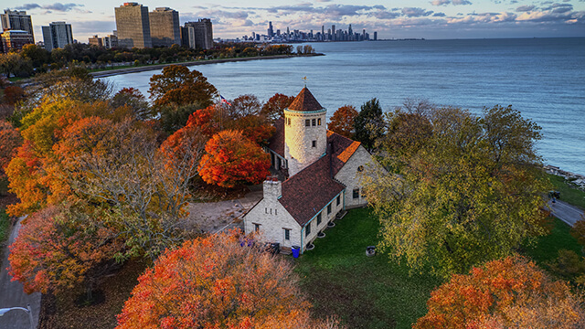 an overhead view of Chicago's Promontory point, with fall foliage and the lake in the background