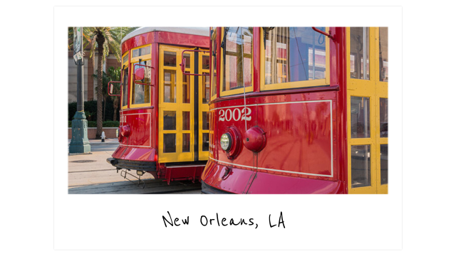 a polaroid photo of the bright red street cars that run in front of HI New Orleans hostel