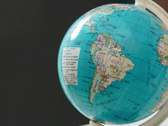 a small globe is turned to show the continent of South America