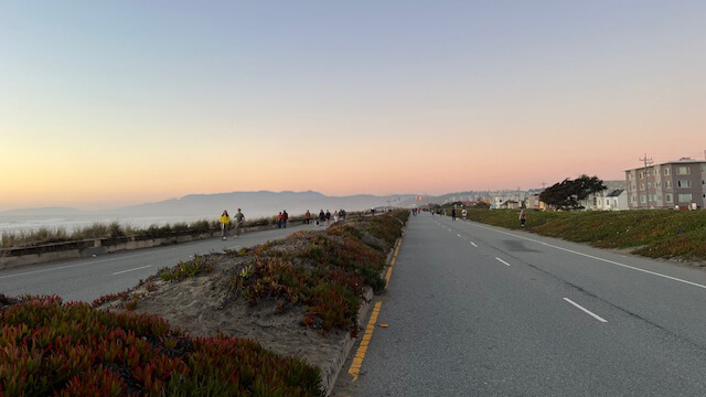 The Great Highway in San Francisco, seen at sunset, is closed to vehicle traffic on weekends and is filled with pedestrians and cyclists.